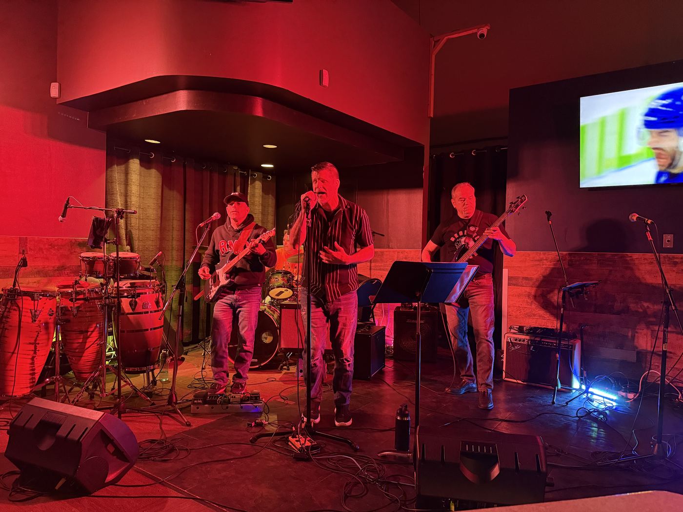 Decibel Crush band members performing together on stage